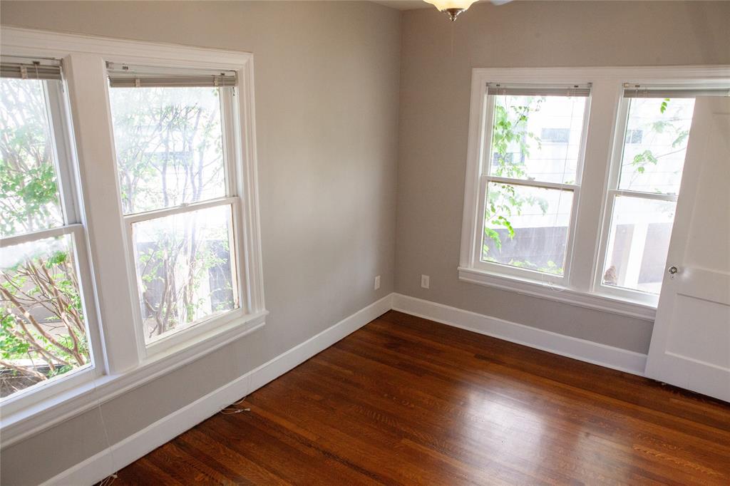 5347 Lewis Street, Unit 5345 Dallas, TX 75206 - Photo 17 of 37 a view of an empty room with wooden floor and a window
