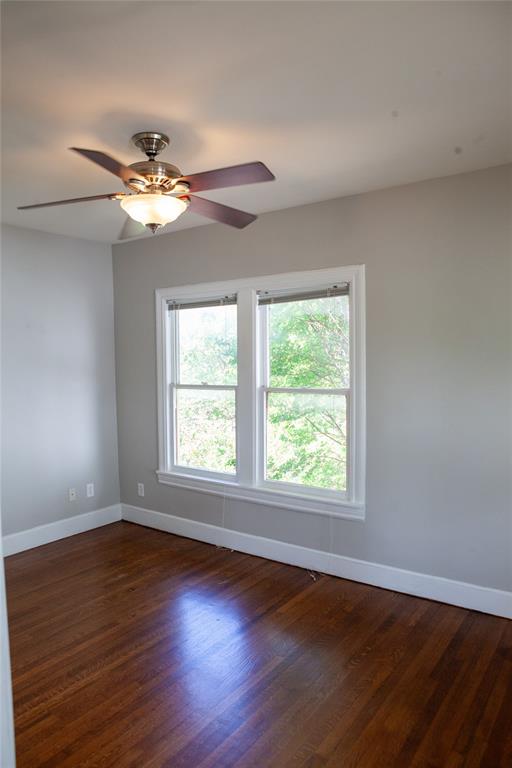 5347 Lewis Street, Unit 5345 Dallas, TX 75206 - Photo 18 of 37 a view of an empty room with wooden floor and a window