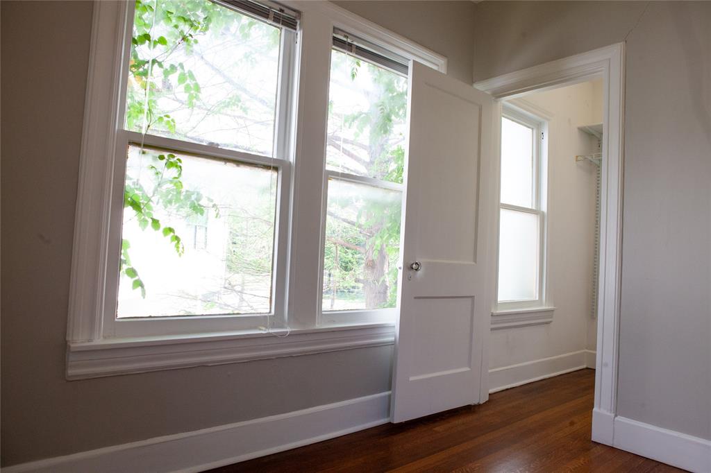 5347 Lewis Street, Unit 5345 Dallas, TX 75206 - Photo 19 of 37 a view of an empty room with wooden floor and a window
