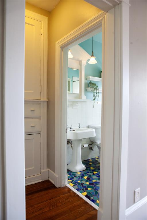 5347 Lewis Street, Unit 5345 Dallas, TX 75206 - Photo 6 of 37 A sneak peek into the stylish bathroom, featuring mosaic tile, and the adjacent built-in linen cabinet.