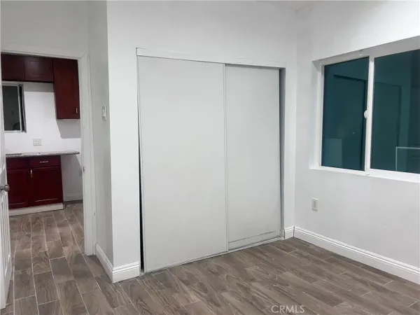 a view of a room with wooden floor
