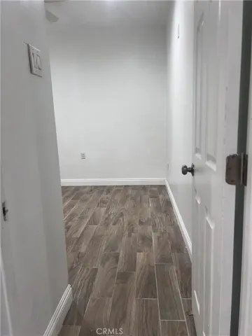 a view of a room with wooden floor