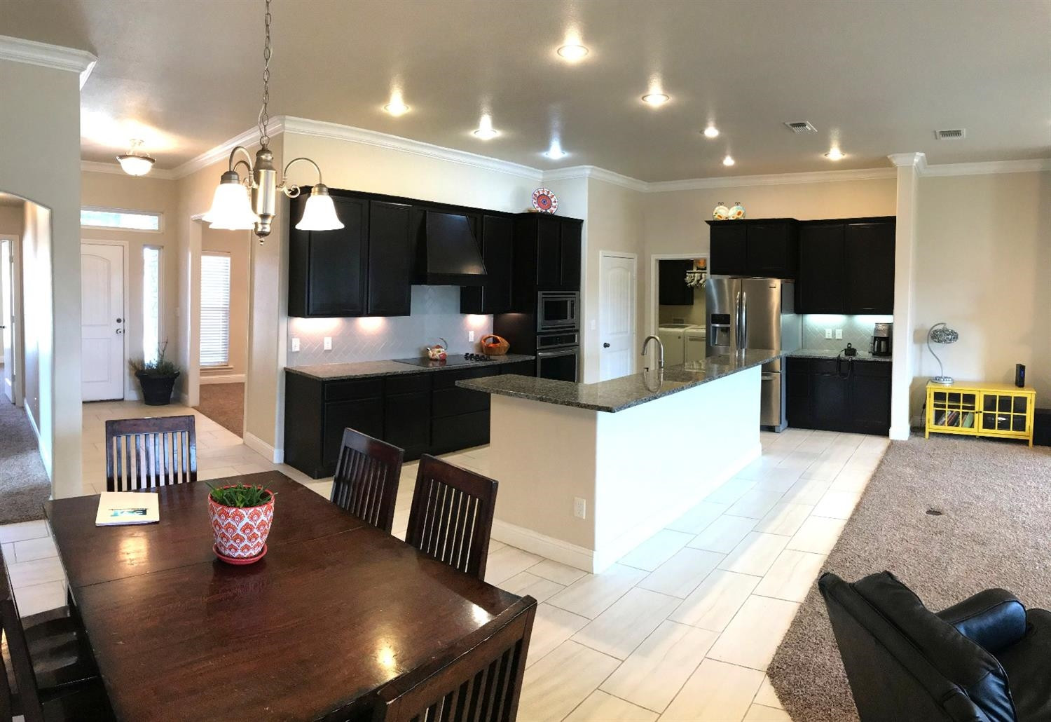 3641 Ridgely Lubbock, TX 79407 - Photo 4 of 10 a large kitchen with kitchen island stainless steel appliances lots of counter space dining table and chairs