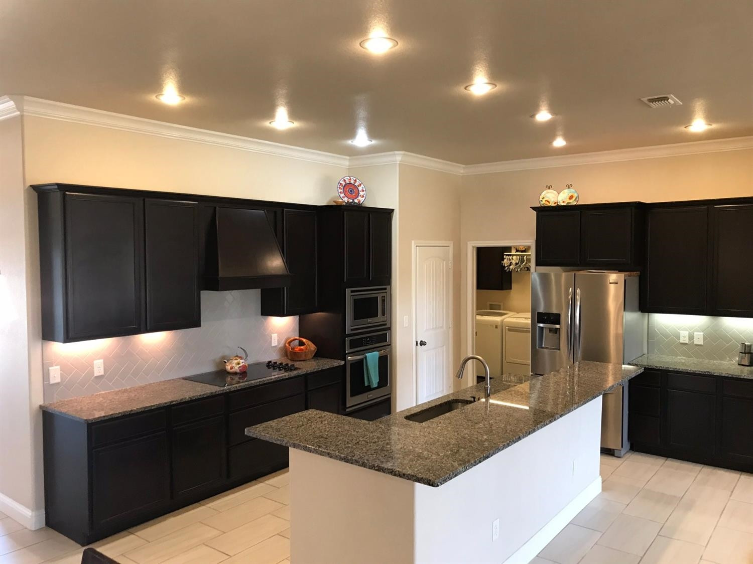 3641 Ridgely Lubbock, TX 79407 - Photo 6 of 10 a kitchen with granite countertop a refrigerator and a sink