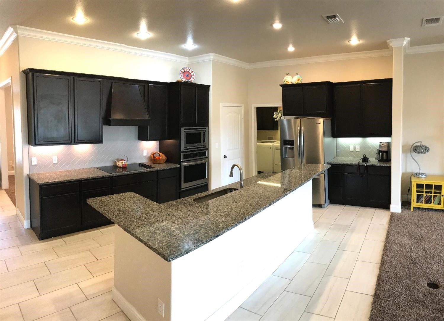 3641 Ridgely Lubbock, TX 79407 - Photo 7 of 10 a kitchen with stainless steel appliances kitchen island granite countertop a refrigerator and a sink