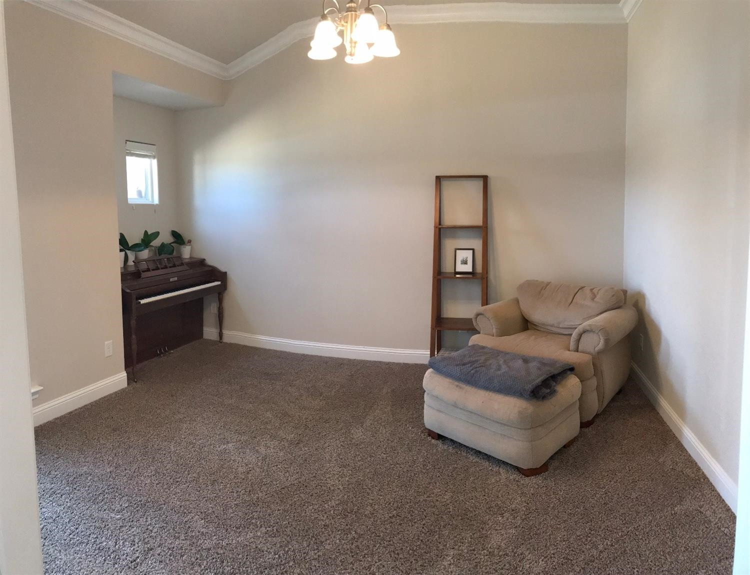 3641 Ridgely Lubbock, TX 79407 - Photo 9 of 10 a living room with furniture and a chandelier