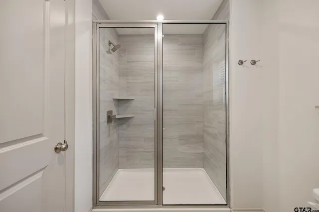a bathroom with a glass shower door