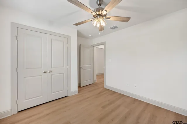 a view of an empty room with a fan