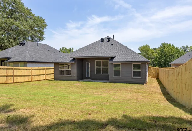 a front view of a house with yard and garage