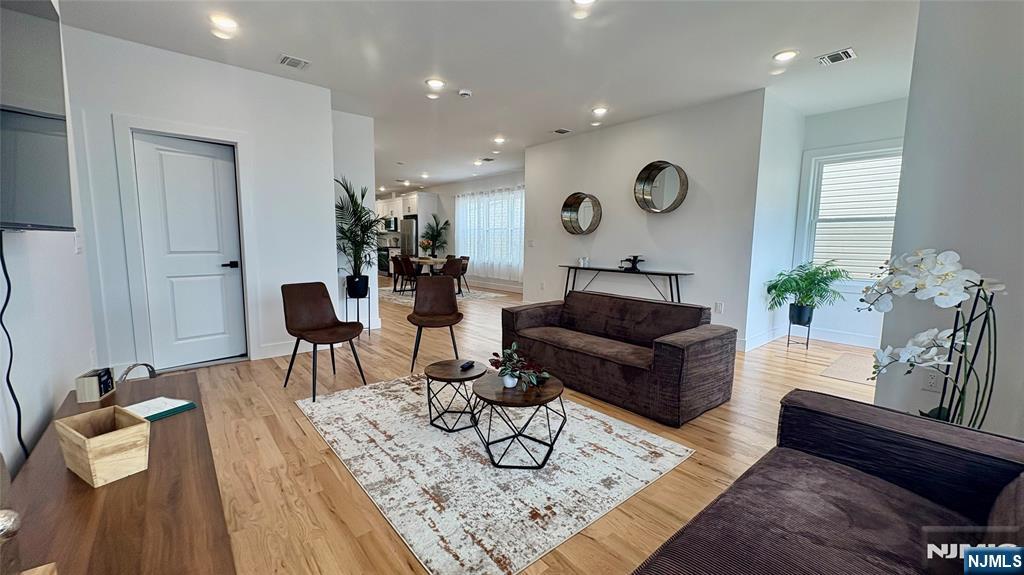 367 Devon Street, Unit 2 Kearny, NJ 07032 - Photo 2 of 30 a living room with furniture and wooden floor