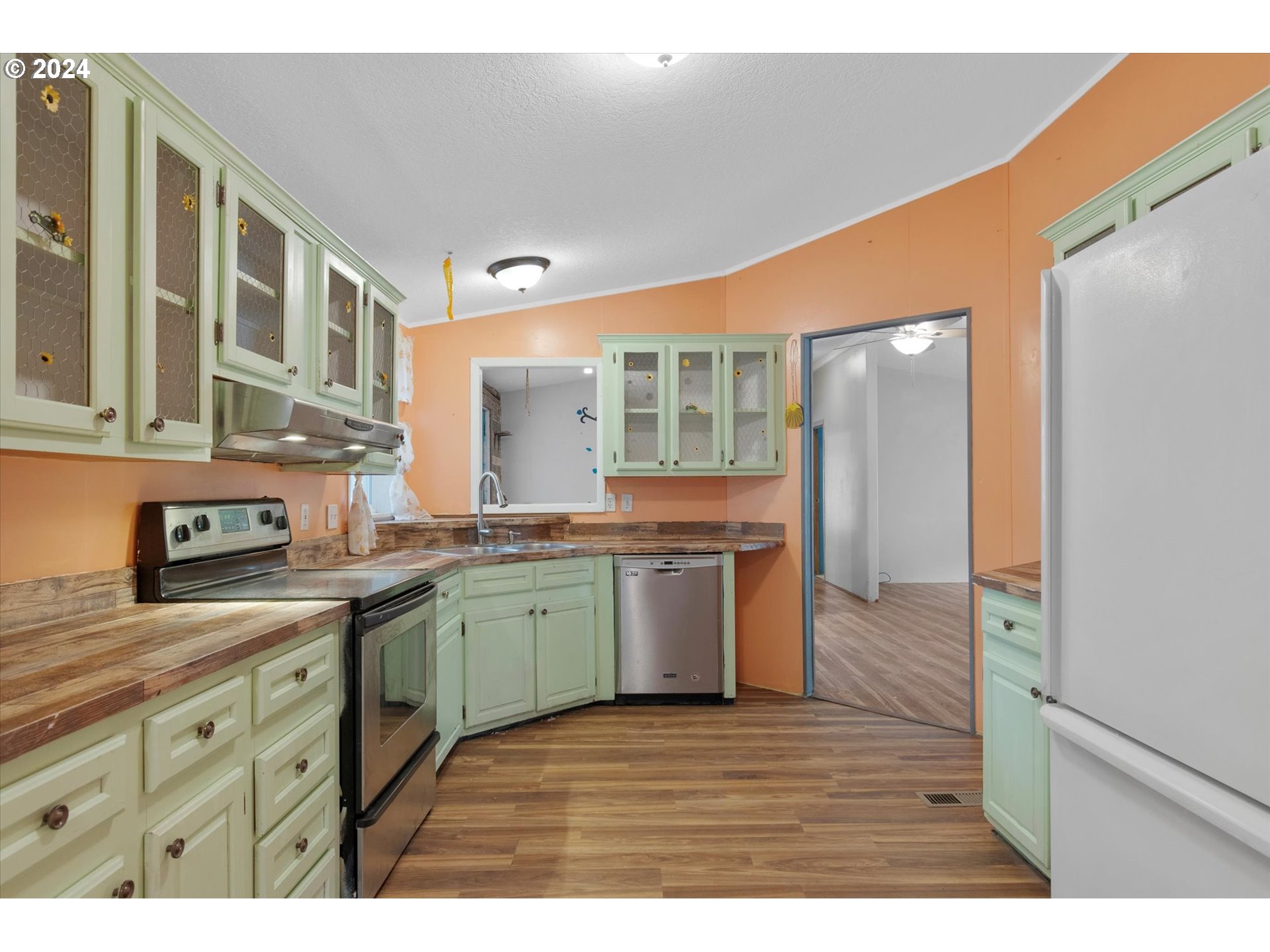 29643 View Street Rainier, OR 97048 - Photo 12 of 31 a kitchen with a sink cabinets and wooden floor