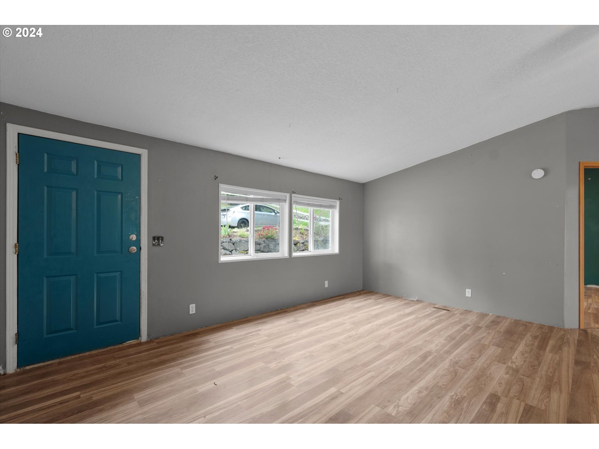 29643 View Street Rainier, OR 97048 - Photo 2 of 31 a view of an empty room with wooden floor and a window