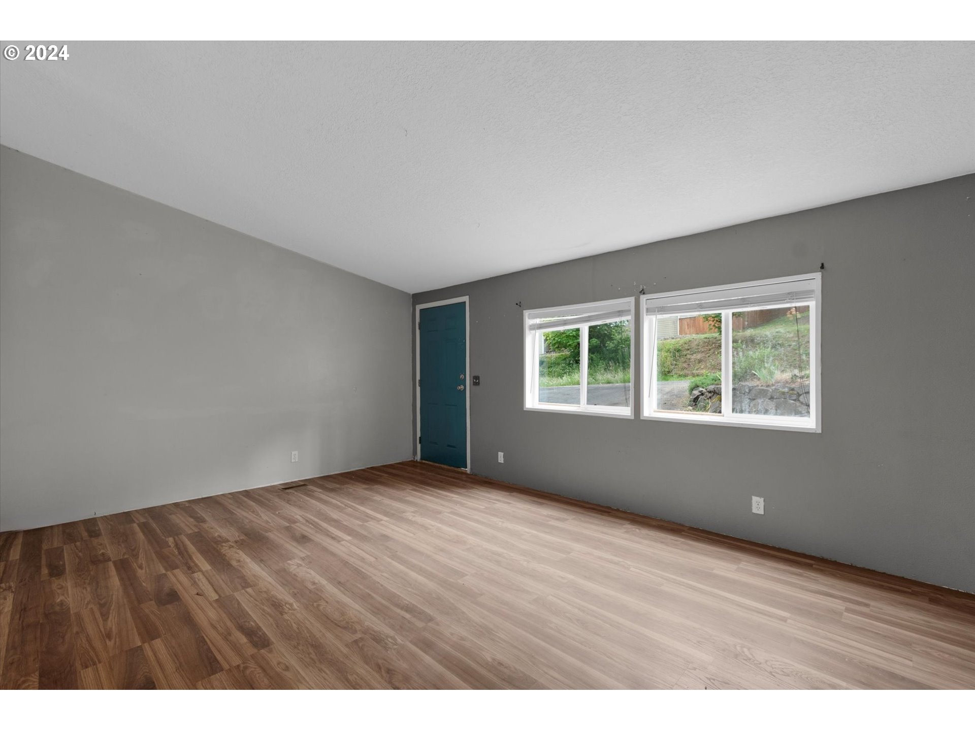 29643 View Street Rainier, OR 97048 - Photo 3 of 31 a view of an empty room with wooden floor and a window