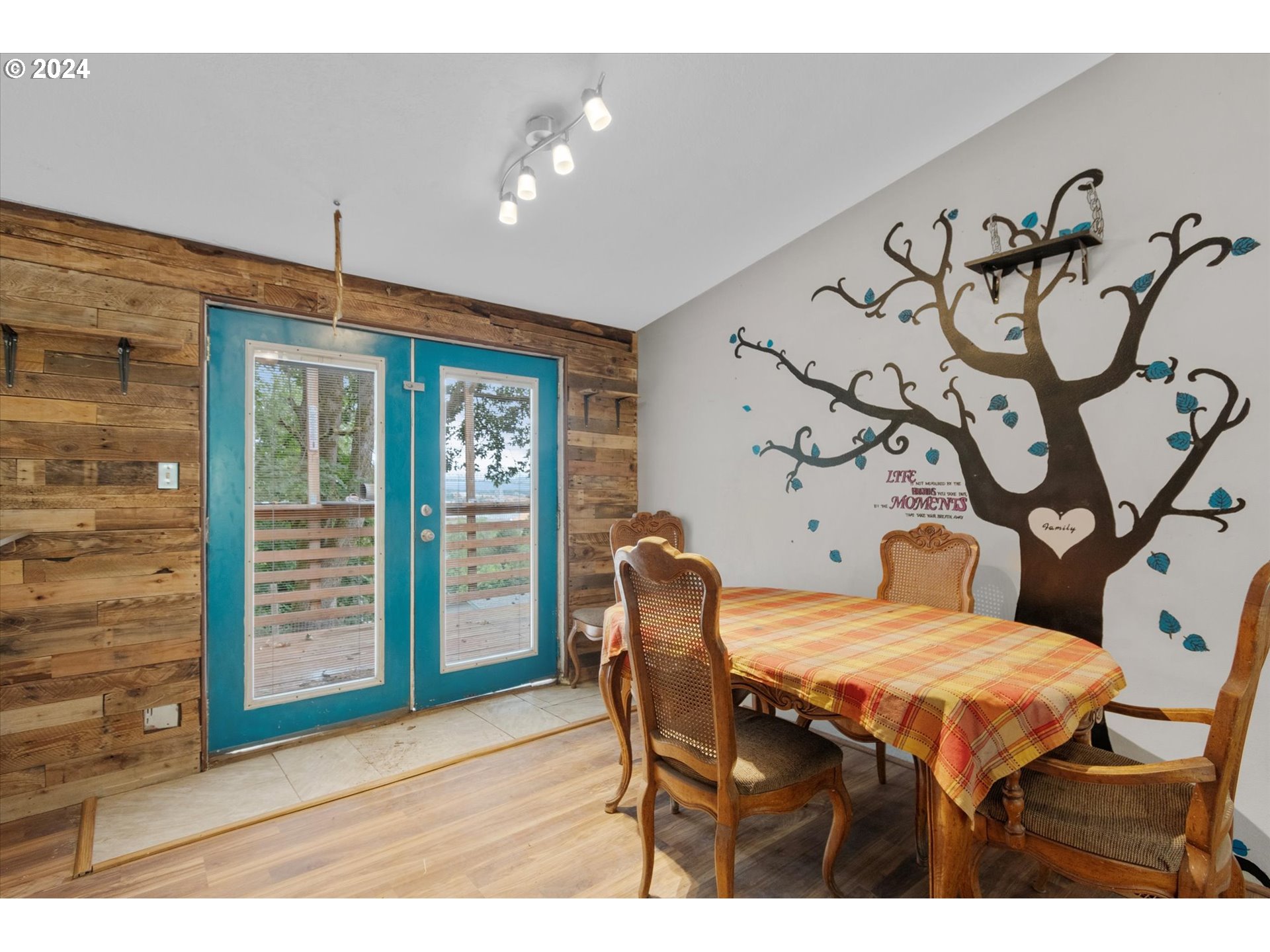 29643 View Street Rainier, OR 97048 - Photo 5 of 31 a bedroom with a large bed and a chandelier