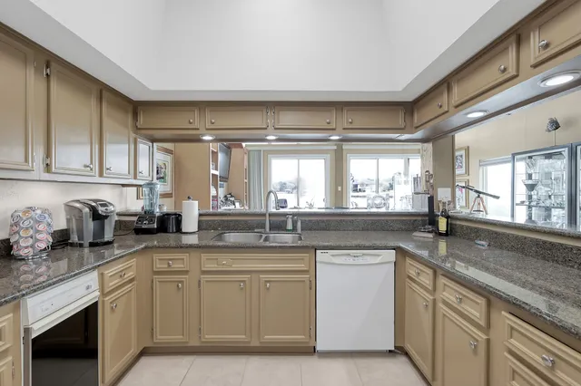 a kitchen with sink a stove and cabinets