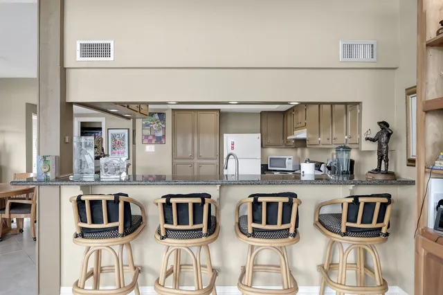 a kitchen with stainless steel appliances granite countertop a stove and a white cabinets