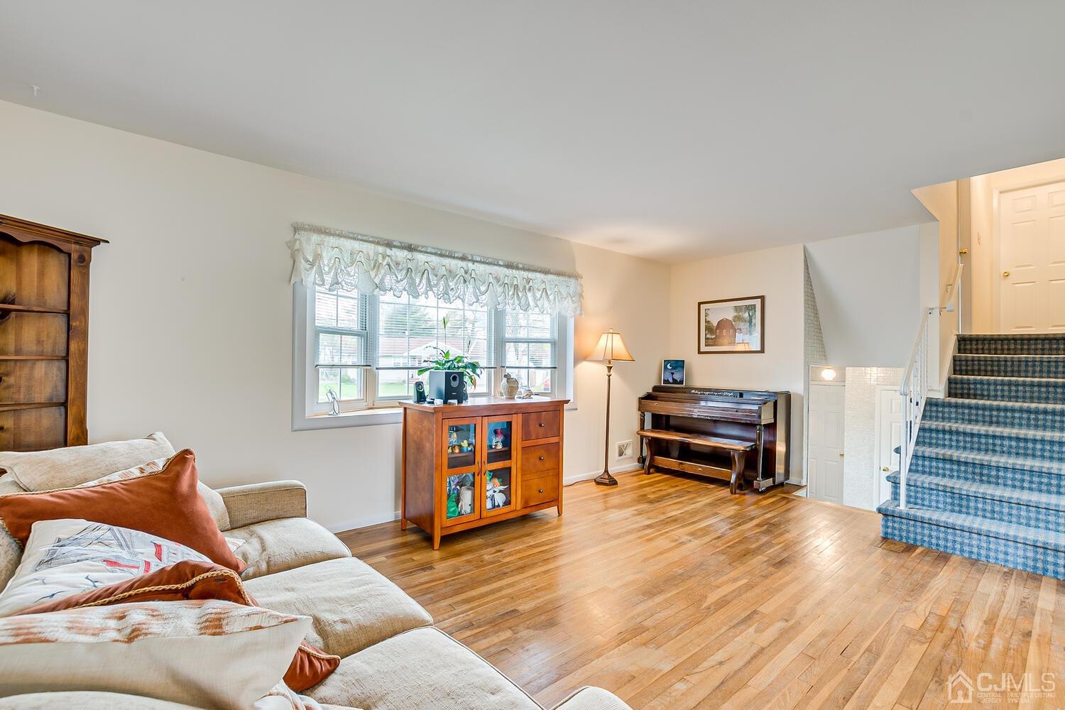 150 Vineyard Road Edison, NJ 08817 - Photo 13 of 33 a living room with furniture a fireplace and a wooden floor