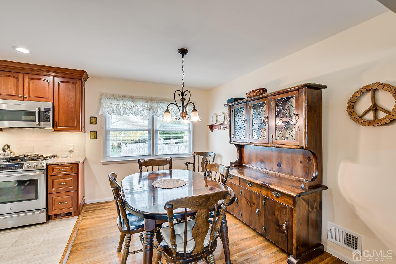 150 Vineyard Road Edison, NJ 08817 - Photo 16 of 33 a view of a dining room with furniture window and wooden floor
