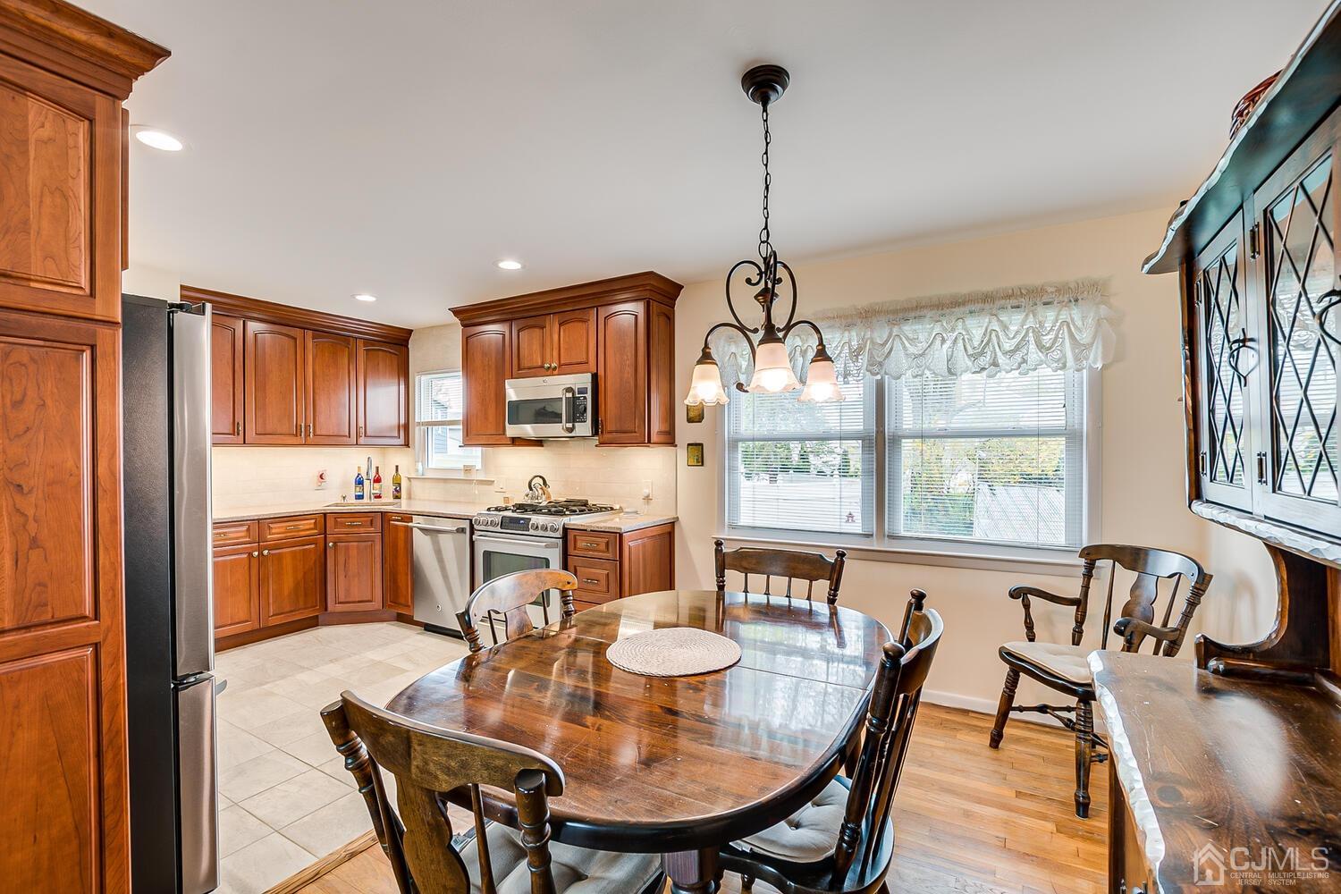 150 Vineyard Road Edison, NJ 08817 - Photo 17 of 33 a view of a dining room and livingroom with furniture wooden floor a chandelier