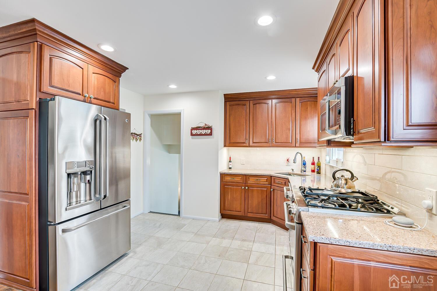150 Vineyard Road Edison, NJ 08817 - Photo 19 of 33 a kitchen with stainless steel appliances granite countertop a refrigerator sink and stove