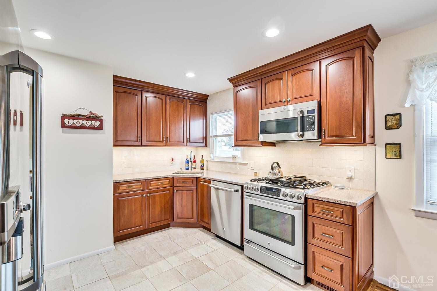 150 Vineyard Road Edison, NJ 08817 - Photo 20 of 33 a kitchen with stainless steel appliances granite countertop a stove sink and microwave