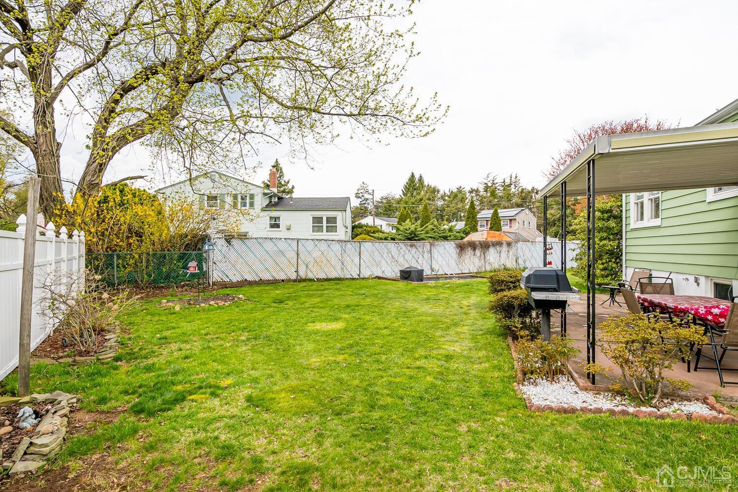 150 Vineyard Road Edison, NJ 08817 - Photo 31 of 33 a view of a patio with table and chairs potted plants and large tree