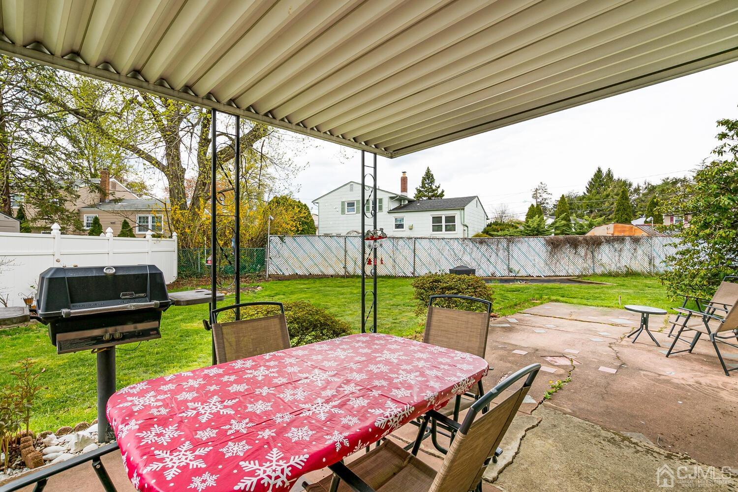 150 Vineyard Road Edison, NJ 08817 - Photo 32 of 33 a view of a backyard with table and chairs under an umbrella with a small yard