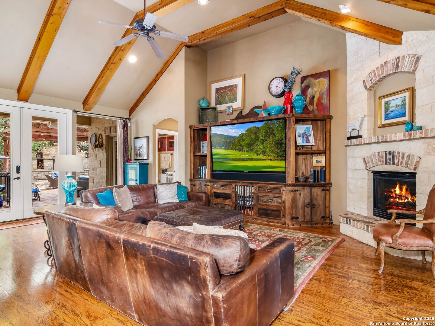 21010 Sky Ridge Avenue San Antonio, TX 78258 - Photo 12 of 70 a living room with fireplace furniture and a flat screen tv
