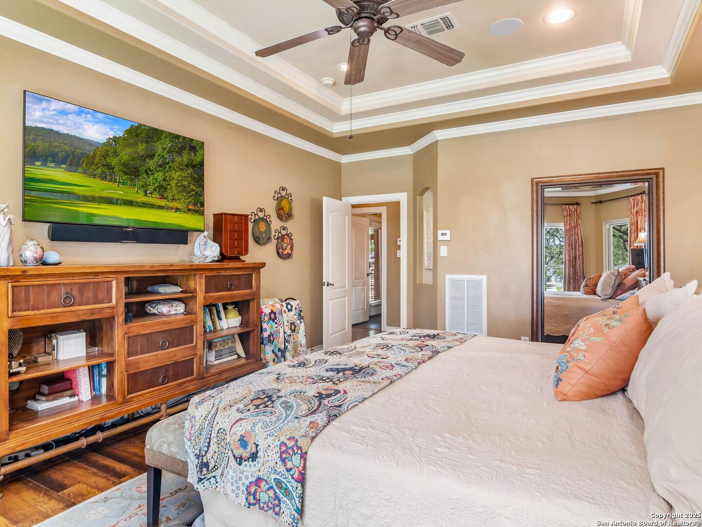 21010 Sky Ridge Avenue San Antonio, TX 78258 - Photo 21 of 70 a bedroom with a bed furniture and a flat screen tv
