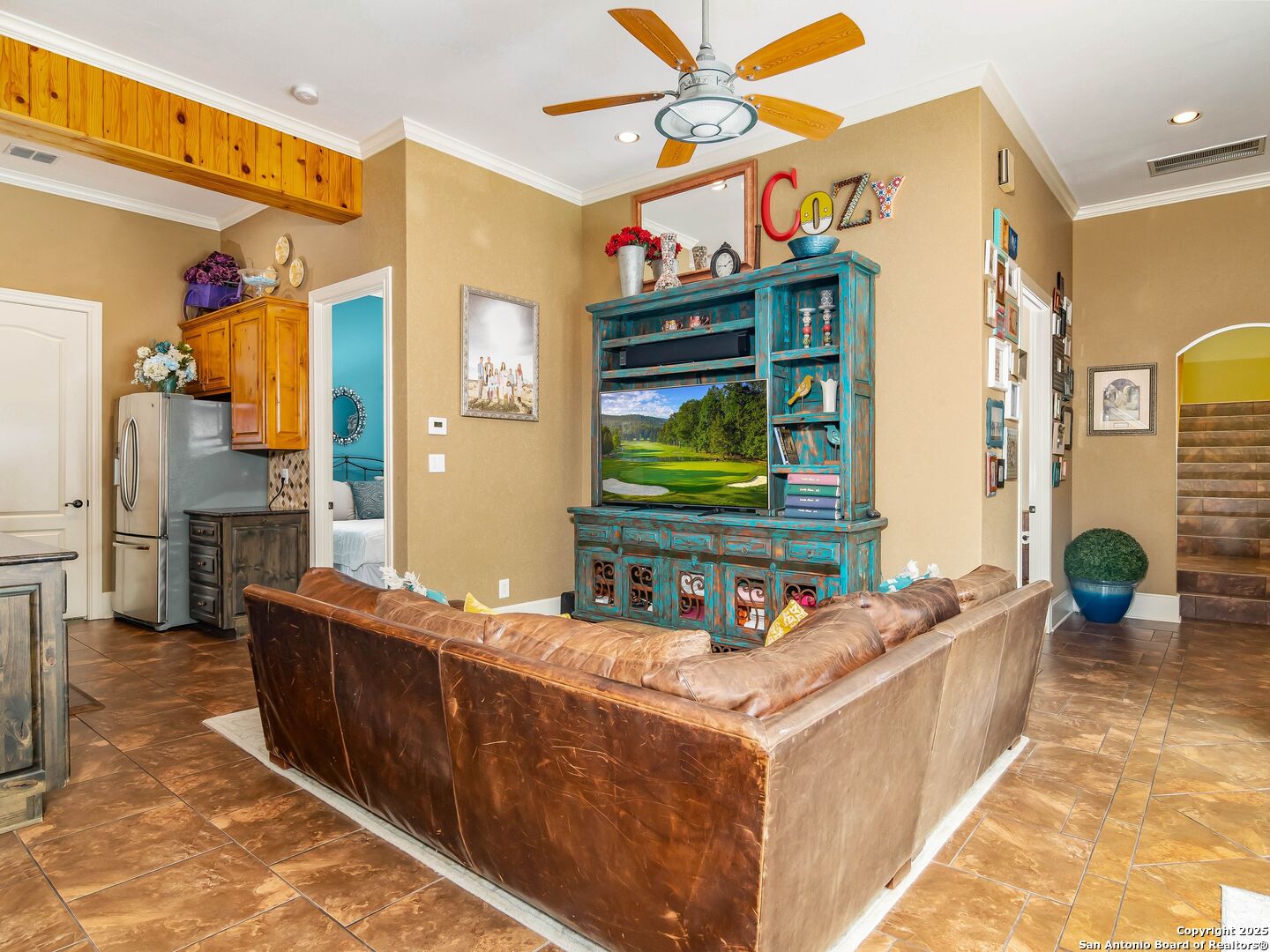 21010 Sky Ridge Avenue San Antonio, TX 78258 - Photo 34 of 70 a living room with stainless steel appliances kitchen island granite countertop furniture and a flat screen tv