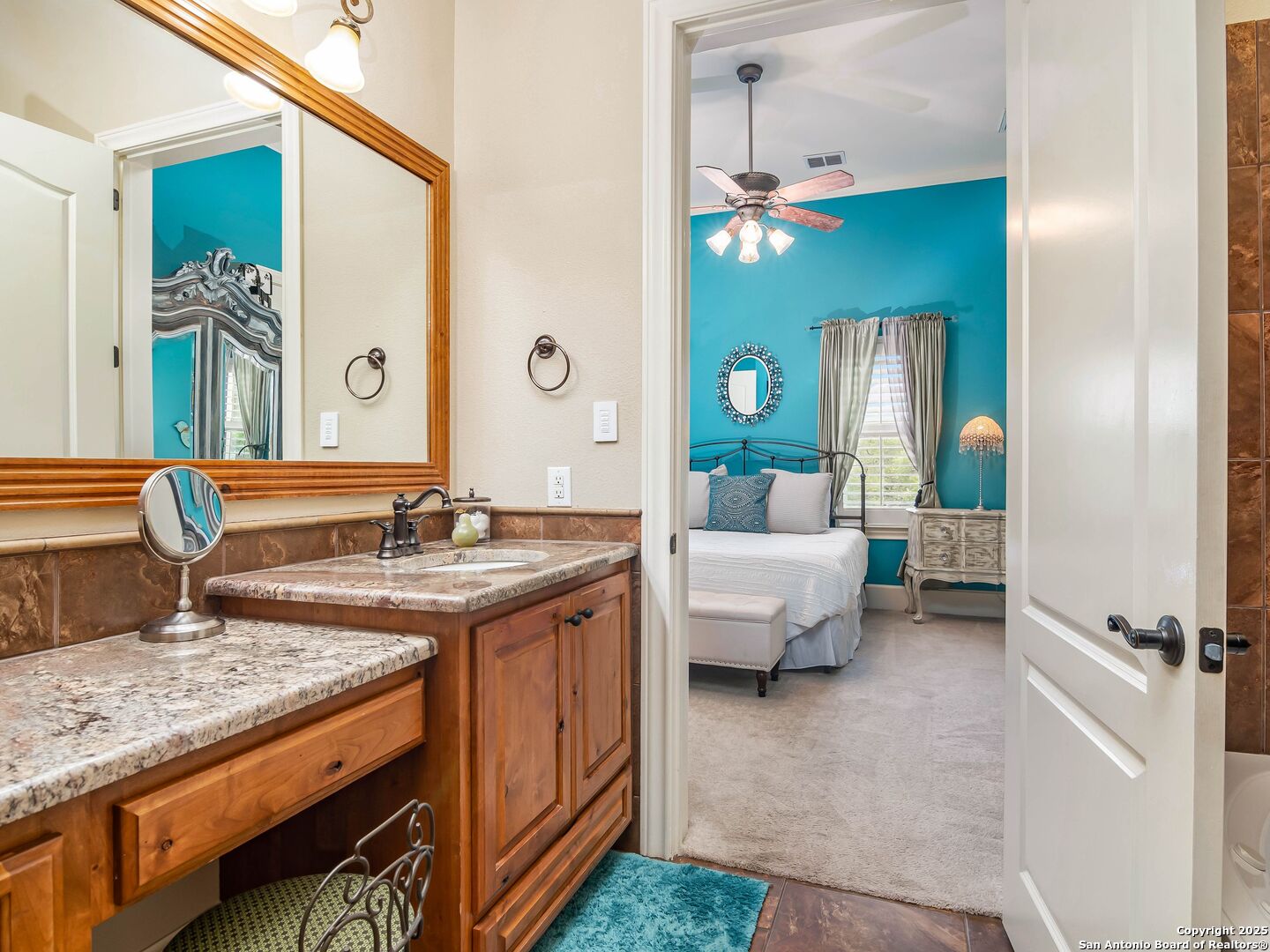 21010 Sky Ridge Avenue San Antonio, TX 78258 - Photo 38 of 70 a spacious bathroom with a granite countertop sink and a mirror