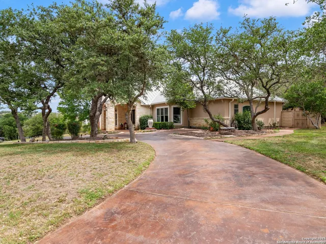a front view of a house with a garden and yard