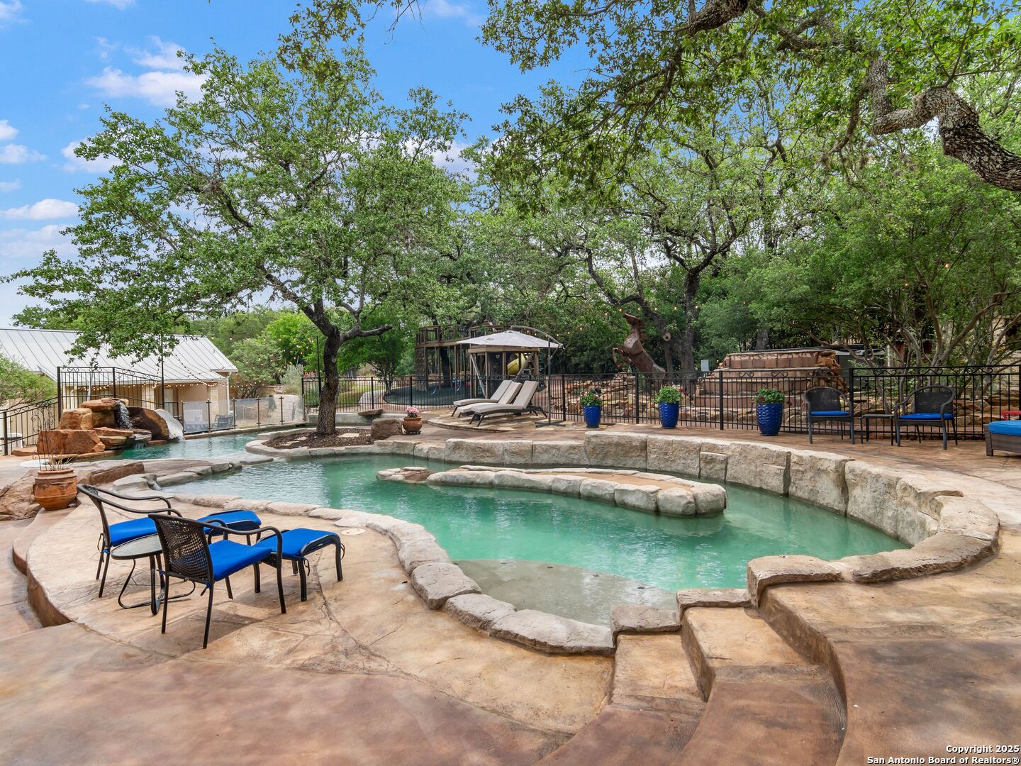 21010 Sky Ridge Avenue San Antonio, TX 78258 - Photo 49 of 70 a view of a swimming pool with chairs in a patio