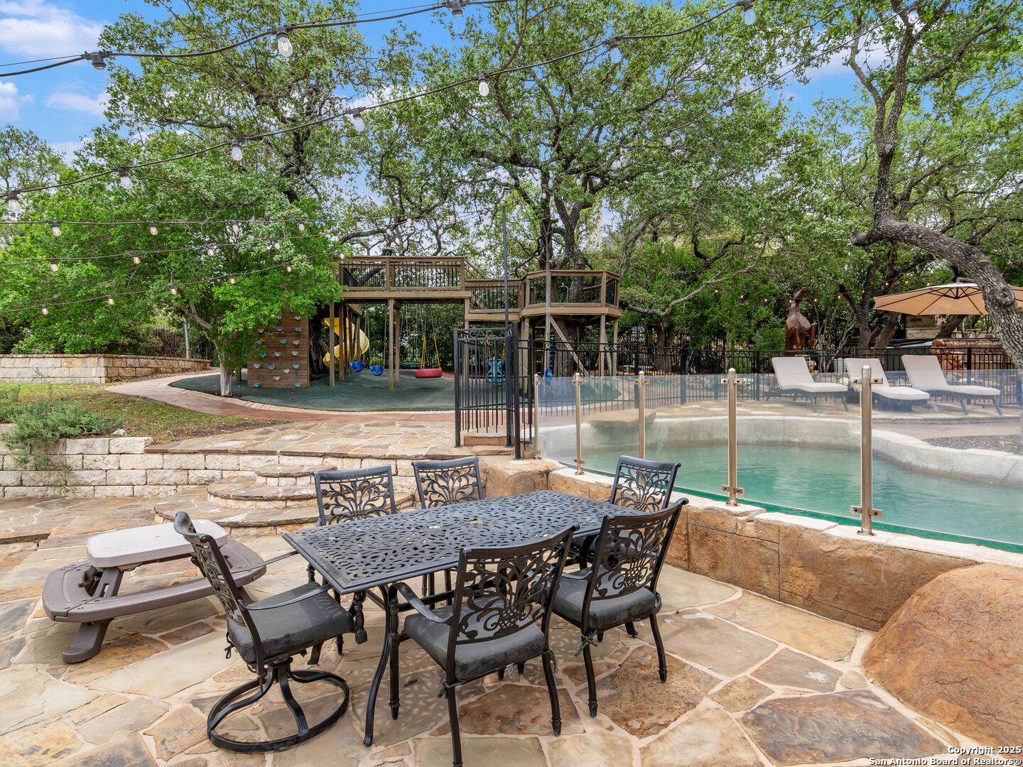 21010 Sky Ridge Avenue San Antonio, TX 78258 - Photo 53 of 70 a view of backyard with seating space and trees in the background