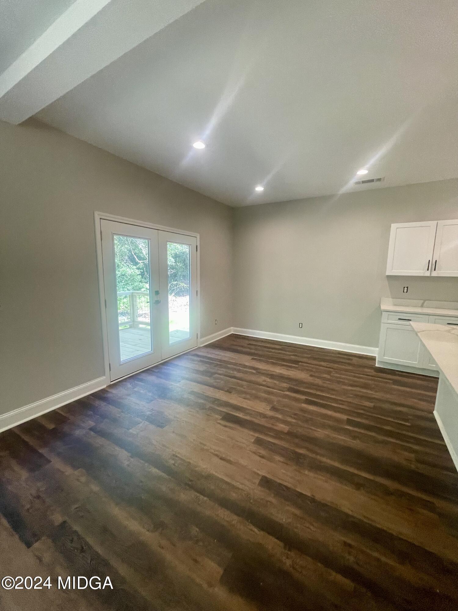 2874 Montpelier Road Forsyth, GA 31029 - Photo 3 of 9 an empty room with wooden floor and windows