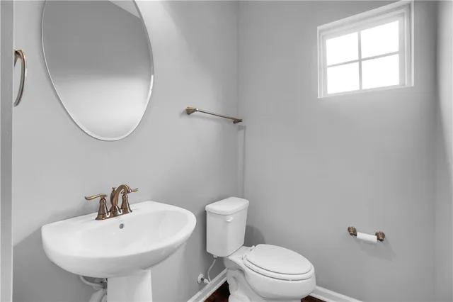 a white toilet sitting next to a bathroom sink