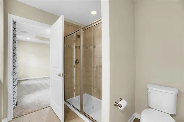 a bathroom with a shower and toilet