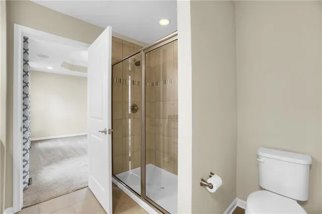 a bathroom with a shower and toilet