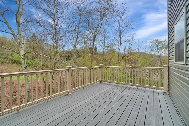 a view of balcony with wooden floor and fence