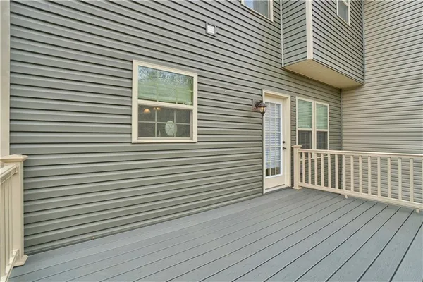 a view of a house with wooden deck