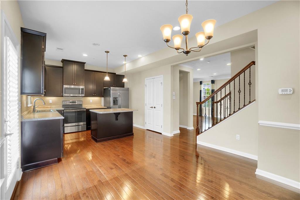 100 Arbor Trail Drive McKees Rocks, PA 15136 - Photo 6 of 22 a living room with stainless steel appliances kitchen island granite countertop a couch a dining table and chairs with wooden floor