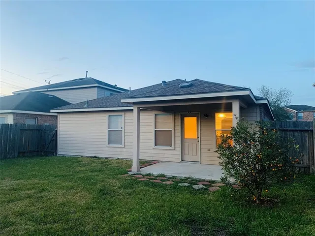 a front view of house with a garden
