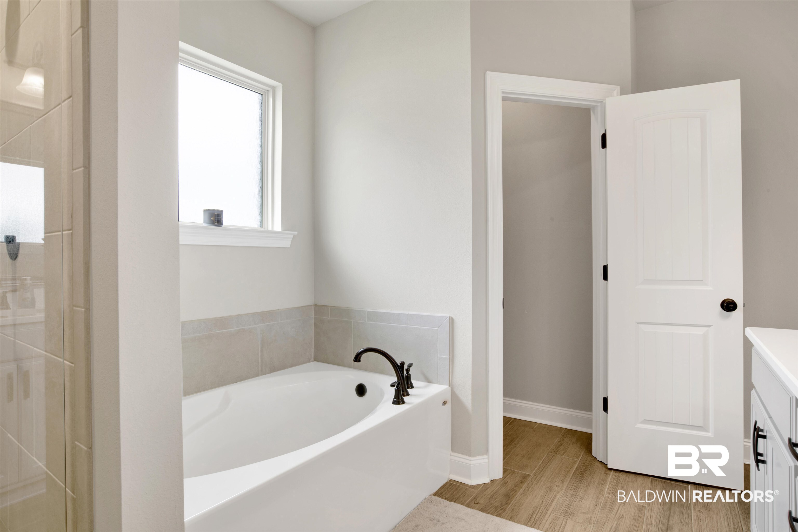 30770 Marcel Boulevard Spanish Fort, AL 36527 - Photo 16 of 23 Bathroom with a tub to relax in, vanity, and hardwood / wood-style flooring