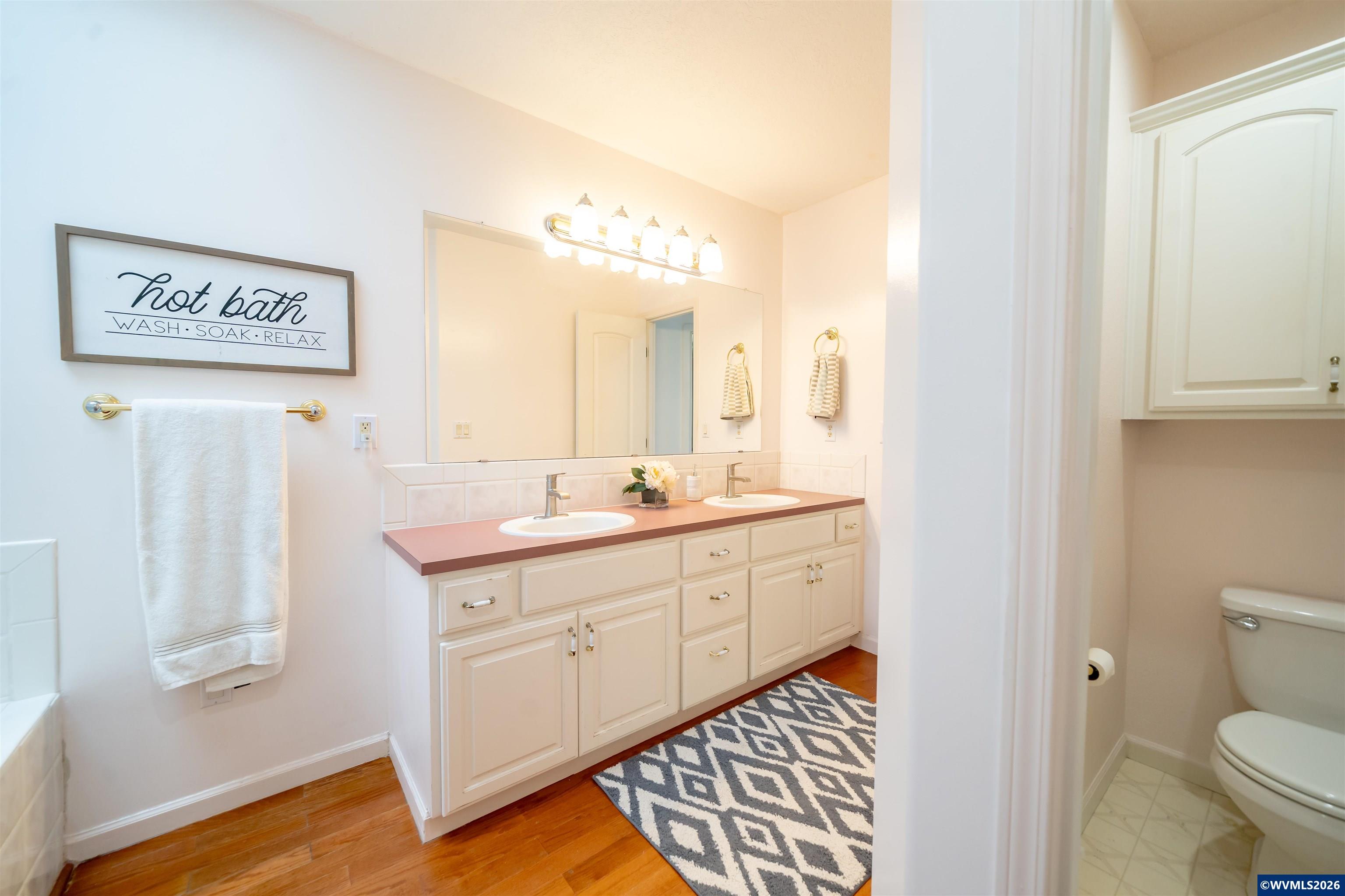 312 Southwest Cascade Meadow Drive Sublimity, OR 97385 - Photo 18 of 42 a spacious bathroom with a sink and a mirror