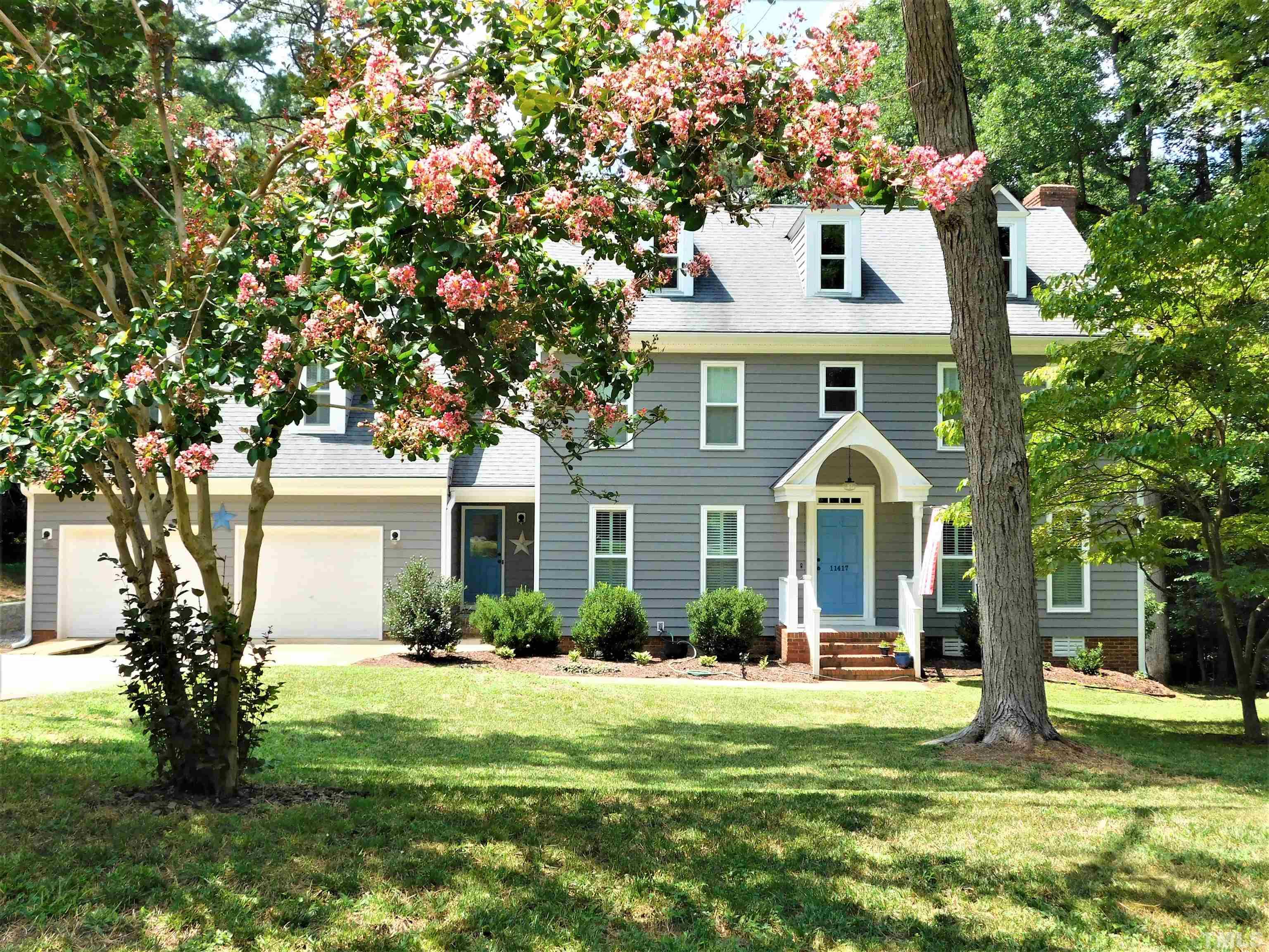 11417 Pacesferry Drive Raleigh, NC 27614 - Photo 1 of 39 a front view of a house with garden