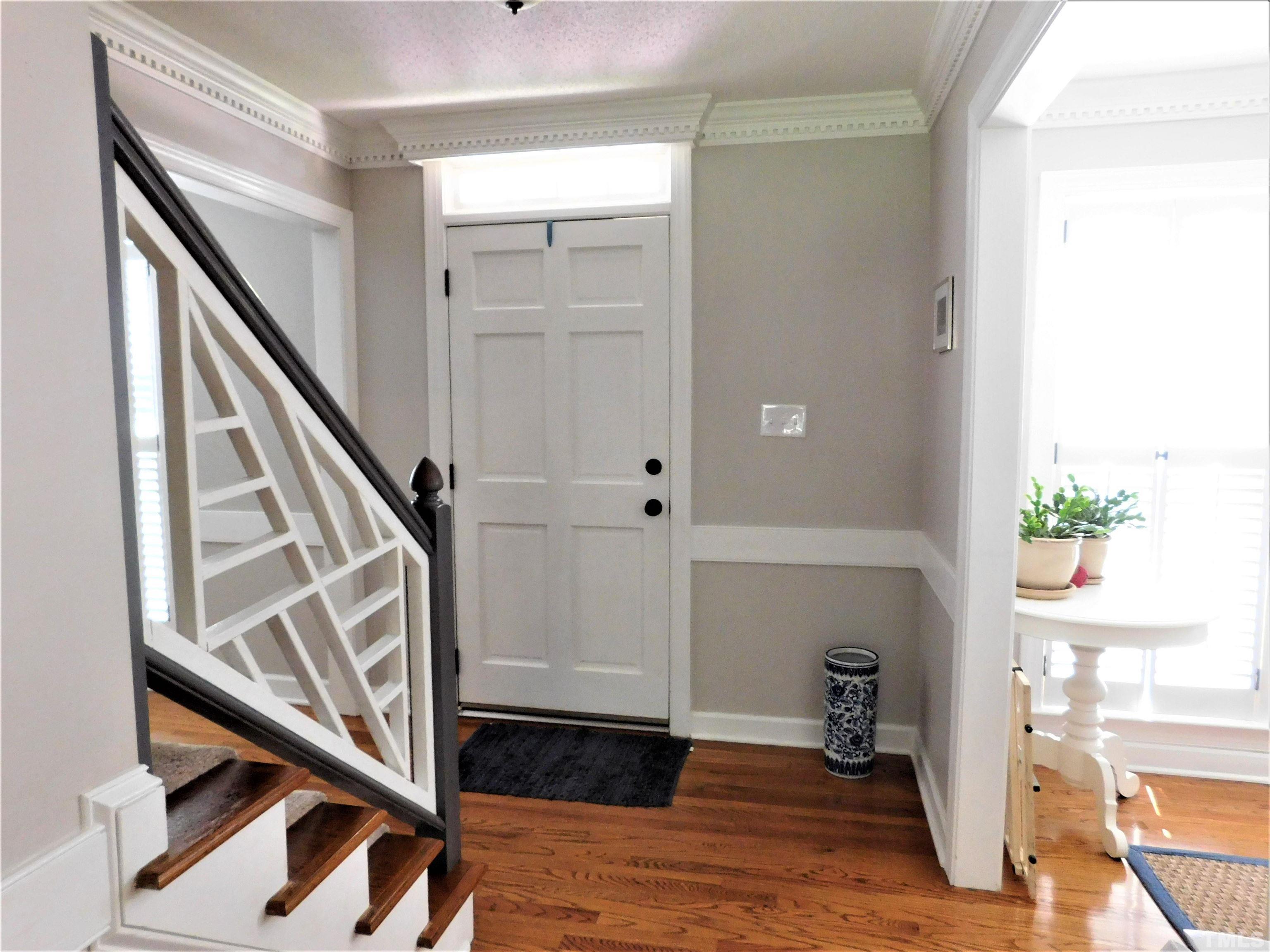 11417 Pacesferry Drive Raleigh, NC 27614 - Photo 11 of 39 a view of an entryway with wooden floor and stairs