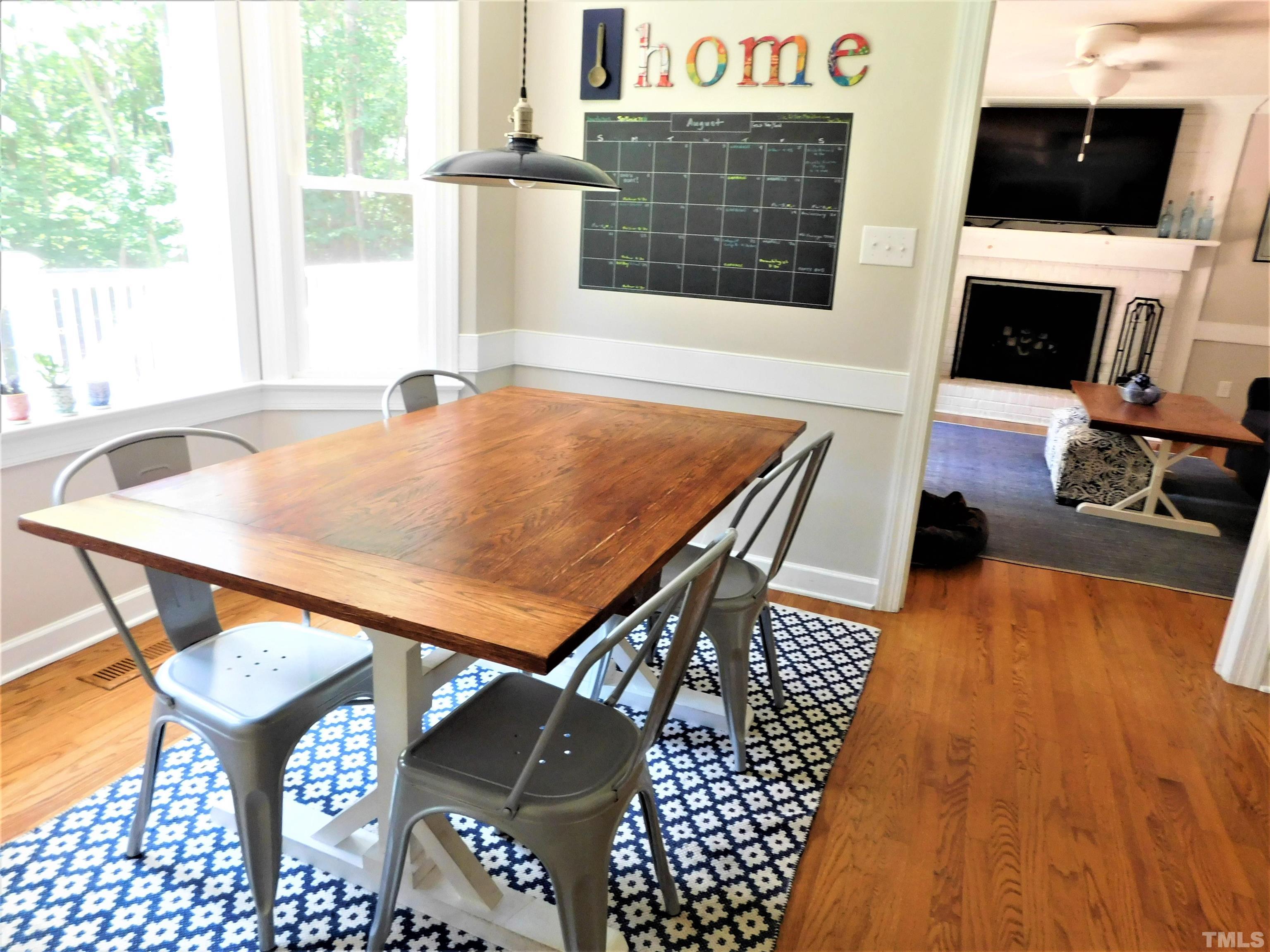 11417 Pacesferry Drive Raleigh, NC 27614 - Photo 16 of 39 a living room with furniture a flat screen tv and a floor to ceiling window