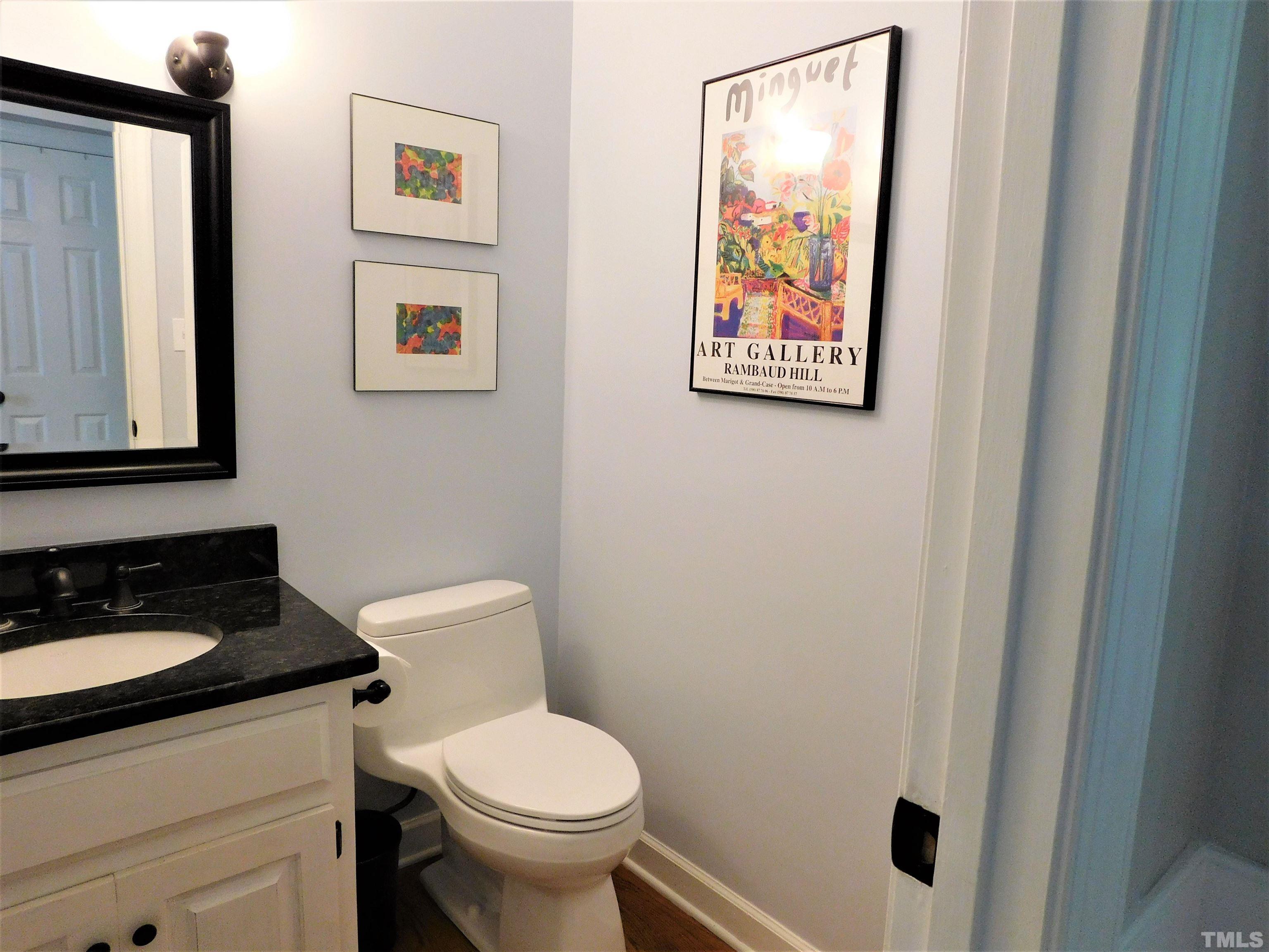 11417 Pacesferry Drive Raleigh, NC 27614 - Photo 18 of 39 a bathroom with a toilet a sink and mirror