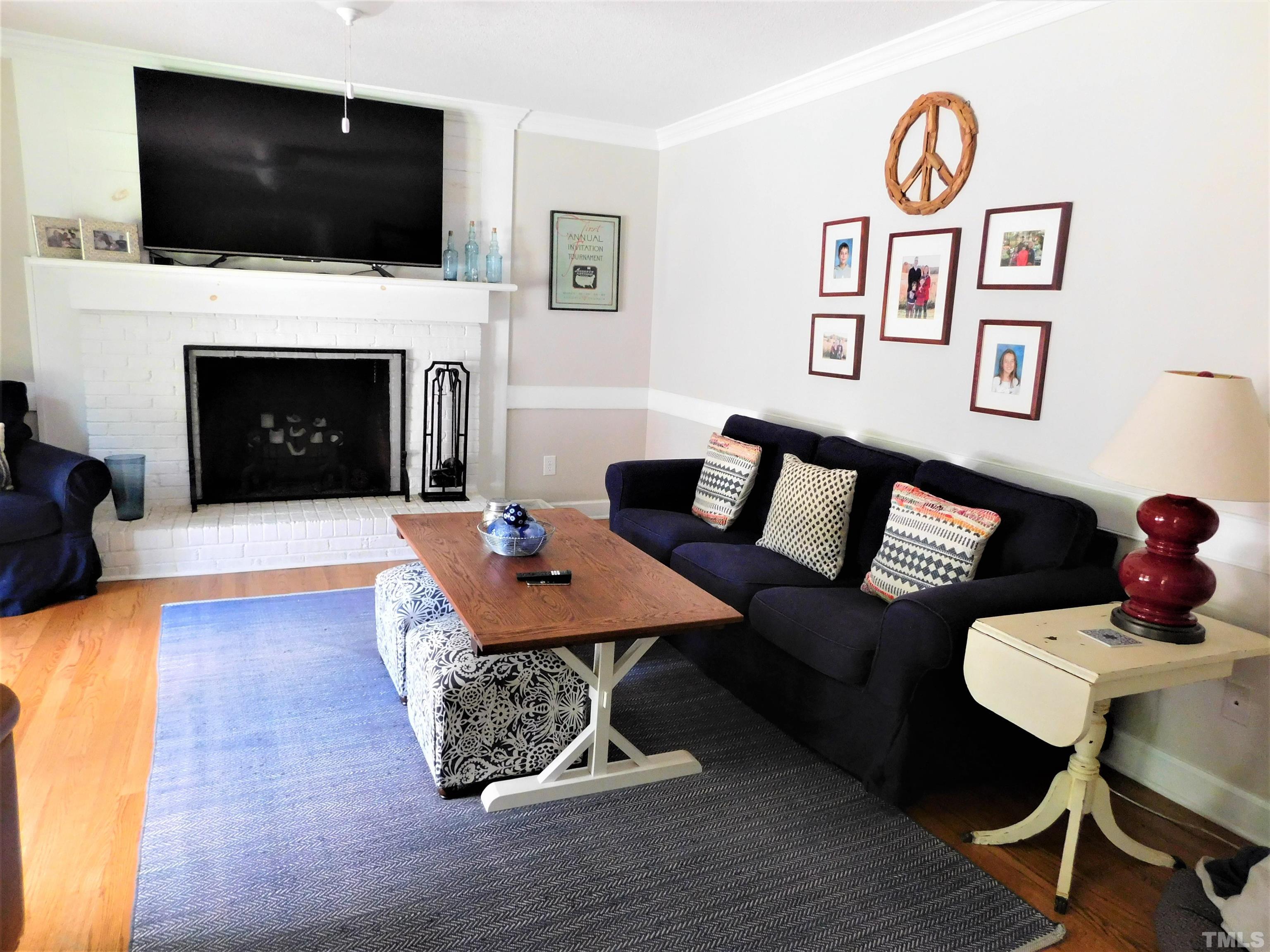 11417 Pacesferry Drive Raleigh, NC 27614 - Photo 19 of 39 a living room with a flat screen tv and a fireplace