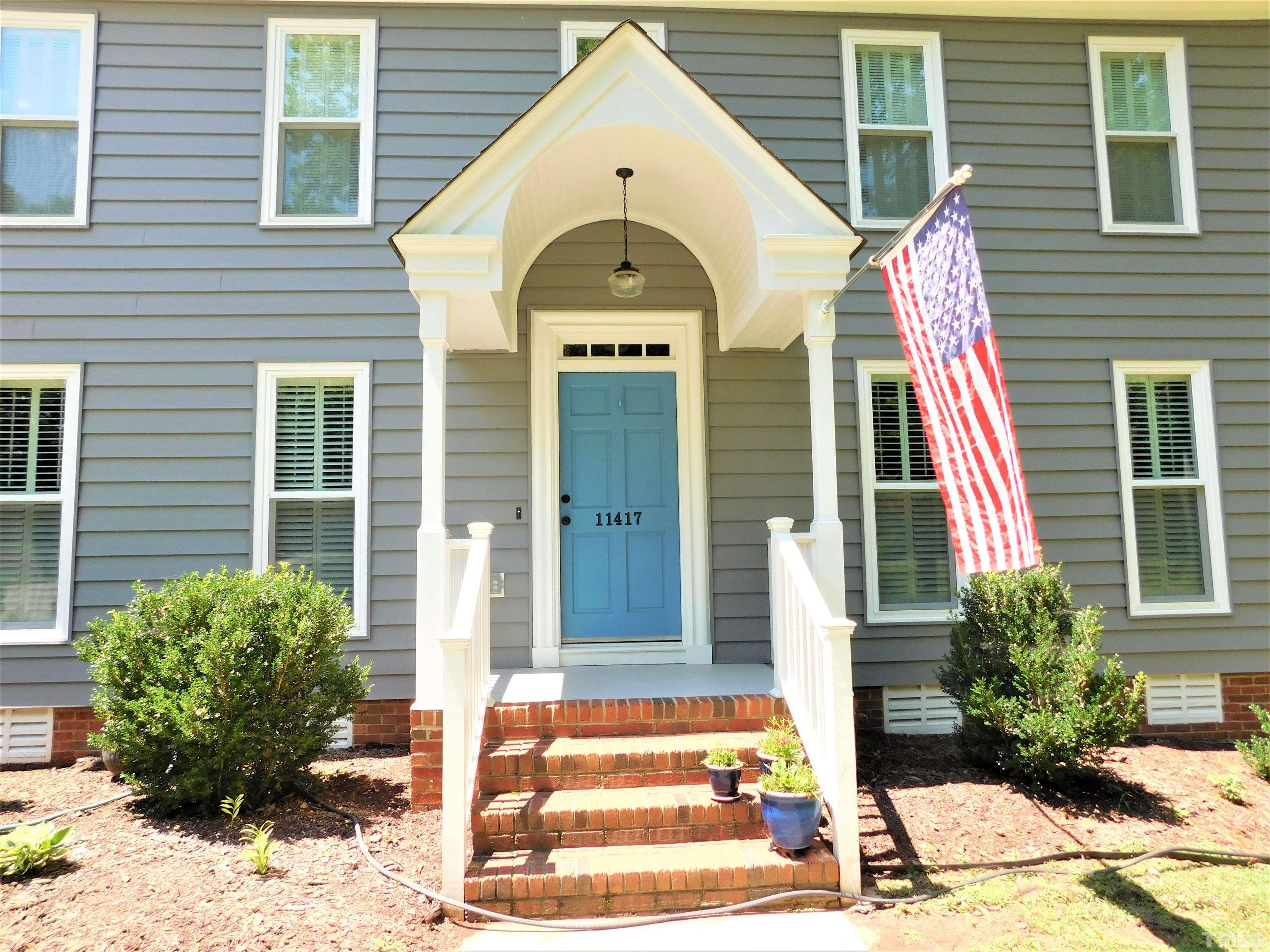 11417 Pacesferry Drive Raleigh, NC 27614 - Photo 2 of 39 a view of a brick house with potted plants